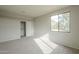 Bedroom with closet and large window, with neutral walls and gray carpet at 25622 N Singbush Loop, Phoenix, AZ 85083