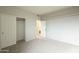 Bedroom with closet and doorway, with neutral walls and gray carpet at 25622 N Singbush Loop, Phoenix, AZ 85083