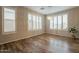 Dining room features stylish chandelier, plantation shutters, wood-look floors, and neutral colored walls at 25622 N Singbush Loop, Phoenix, AZ 85083