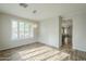 Bright dining room with wood floors, modern lighting, and large window with plantation shutters at 25622 N Singbush Loop, Phoenix, AZ 85083