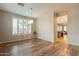 Dining room features stylish chandelier, plantation shutters, wood-look floors, and neutral colored walls at 25622 N Singbush Loop, Phoenix, AZ 85083