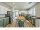 Bright kitchen featuring two-tone cabinets, stainless steel appliances, and an island with bar seating at 25622 N Singbush Loop, Phoenix, AZ 85083