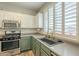 Well-lit kitchen showcasing stainless steel appliances, modern sink, and lots of storage at 25622 N Singbush Loop, Phoenix, AZ 85083