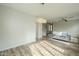 Open-concept living room features wood floors and modern lighting fixtures at 25622 N Singbush Loop, Phoenix, AZ 85083