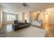 Comfortable living room with neutral tones, plush carpeting, large windows, and an open staircase at 25622 N Singbush Loop, Phoenix, AZ 85083