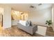 Bright living room with wood-look floors features neutral tones, a comfortable couch, and access to the foyer at 25622 N Singbush Loop, Phoenix, AZ 85083