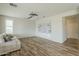 Bright living room features wood flooring, ceiling fan, and custom built-in shelving at 25622 N Singbush Loop, Phoenix, AZ 85083