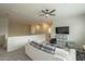 Open living room area featuring plush seating, entertainment center, and ceiling fan at 25622 N Singbush Loop, Phoenix, AZ 85083