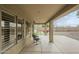 Covered patio with rocking chairs provides shade and outdoor living space at 25622 N Singbush Loop, Phoenix, AZ 85083