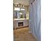 Bathroom featuring double sinks, neutral countertop, and decorative plant centerpiece with tile floors at 2605 E Geneva Dr, Tempe, AZ 85282