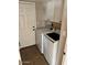 Laundry room featuring tile floors, washer and dryer and built-in cabinets at 2605 E Geneva Dr, Tempe, AZ 85282