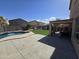 Backyard showcasing a pool, patio, and well-maintained lawn for outdoor activities at 28273 N Castle Rock Dr, San Tan Valley, AZ 85143