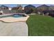 Large backyard featuring artificial turf and a pool perfect for entertaining and relaxation at 28273 N Castle Rock Dr, San Tan Valley, AZ 85143