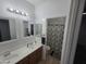 Bathroom featuring double sink vanity and shower with patterned curtain at 28273 N Castle Rock Dr, San Tan Valley, AZ 85143