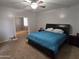 Bright bedroom boasts ceiling fan and neutral carpet at 28273 N Castle Rock Dr, San Tan Valley, AZ 85143