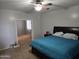 View of a bedroom with carpet flooring, neutral paint, ceiling fan and ensuite bath at 28273 N Castle Rock Dr, San Tan Valley, AZ 85143