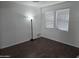 Bedroom with hardwood floors and natural light streaming through two large windows at 28273 N Castle Rock Dr, San Tan Valley, AZ 85143