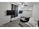 Stylish bedroom with a ceiling fan and two wall-mounted televisions at 28273 N Castle Rock Dr, San Tan Valley, AZ 85143