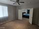 Spacious bedroom with ceiling fan, carpeting, and entry to another room at 28273 N Castle Rock Dr, San Tan Valley, AZ 85143