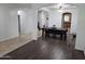 Dining room with hardwood floors, bench seating, and an arched entryway leading to the kitchen at 28273 N Castle Rock Dr, San Tan Valley, AZ 85143