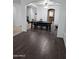 Dining room with hardwood floors, bench seating, and an arched entryway leading to the kitchen at 28273 N Castle Rock Dr, San Tan Valley, AZ 85143