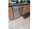 Stainless steel dishwasher is surrounded by granite countertops and wood cabinets with ceramic flooring at 28273 N Castle Rock Dr, San Tan Valley, AZ 85143