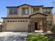 Charming two-story home featuring a brick-accented entryway and a spacious two-car garage at 28273 N Castle Rock Dr, San Tan Valley, AZ 85143