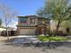 Inviting two-story home highlighting a well-manicured lawn and a spacious driveway at 28273 N Castle Rock Dr, San Tan Valley, AZ 85143