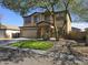 Inviting two-story home featuring a well-manicured lawn and mature shade tree at 28273 N Castle Rock Dr, San Tan Valley, AZ 85143