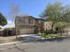 Welcoming two-story home featuring a well-kept lawn and a charming brick-accented entryway at 28273 N Castle Rock Dr, San Tan Valley, AZ 85143