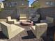 Backyard area featuring a custom fire pit with stone seating and desert landscaping at 28273 N Castle Rock Dr, San Tan Valley, AZ 85143