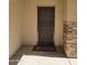 Inviting front porch with a secure screen door, brick accents, and a welcoming doormat at 28273 N Castle Rock Dr, San Tan Valley, AZ 85143