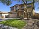 Beautiful two-story home with well-manicured lawn and three car garage at 28273 N Castle Rock Dr, San Tan Valley, AZ 85143