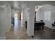 Bright hallway with tiled floors, arched doorways, and views of dining and living areas at 28273 N Castle Rock Dr, San Tan Valley, AZ 85143