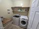 Convenient laundry room equipped with washer, dryer, shelf and storage space at 28273 N Castle Rock Dr, San Tan Valley, AZ 85143