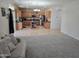 Living room view showcasing the open floorplan and view into the kitchen with stainless appliances at 28273 N Castle Rock Dr, San Tan Valley, AZ 85143