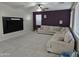 Bright living room featuring plush gray carpeting, a ceiling fan, and a large comfortable sectional sofa at 28273 N Castle Rock Dr, San Tan Valley, AZ 85143