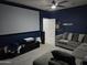 Home theater with a projector, large screen, sectional couch, and a dart board for entertaining friends and Gathering at 28273 N Castle Rock Dr, San Tan Valley, AZ 85143