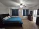 View of the main bedroom with a ceiling fan, carpeted floors, curtains, and a large bed at 28273 N Castle Rock Dr, San Tan Valley, AZ 85143