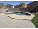 Backyard pool and patio area with lush artificial turf and landscaping at 28273 N Castle Rock Dr, San Tan Valley, AZ 85143