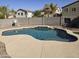 Backyard pool with a basketball hoop, tanning ledge, and lush artificial turf lawn at 28273 N Castle Rock Dr, San Tan Valley, AZ 85143