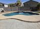 Backyard view with a sparkling pool featuring a soothing waterfall feature at 28273 N Castle Rock Dr, San Tan Valley, AZ 85143