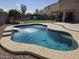 Inviting pool featuring a waterfall and surrounded by lush landscaping at 28273 N Castle Rock Dr, San Tan Valley, AZ 85143