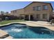 Backyard pool with water feature, patio, and lush green artificial turf lawn for Gathering recreation at 28273 N Castle Rock Dr, San Tan Valley, AZ 85143