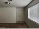 Bright living room featuring a neutral color palette, a large window, and plush carpeting at 2875 W Muriel Dr, Phoenix, AZ 85053