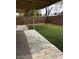 Covered patio overlooking a backyard with artificial turf, and mature tree at 2875 W Muriel Dr, Phoenix, AZ 85053