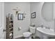 Charming powder room with unique decor, pedestal sink, and neutral color scheme at 2928 E Palm St, Mesa, AZ 85213