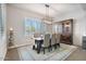 Bright dining room with large windows, a modern chandelier, and a wooden hutch at 2928 E Palm St, Mesa, AZ 85213