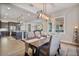 Elegant dining room featuring modern lighting and views into the open kitchen and living spaces at 2928 E Palm St, Mesa, AZ 85213