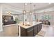 Open layout showing the kitchen island, modern pendant lights, and seamless flow into the dining and living areas at 2928 E Palm St, Mesa, AZ 85213